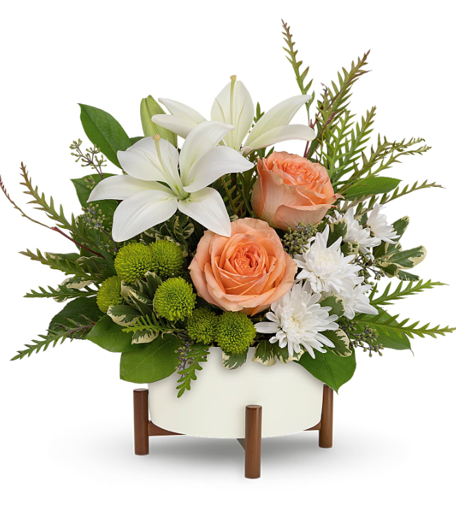 Mod Blooms Bouquet floral arrangement by Days Flowers Florida, showcasing soft peach roses, a white Asiatic lily, and green button chrysanthemums inside a white mid-century planter with a decorative wooden stand.