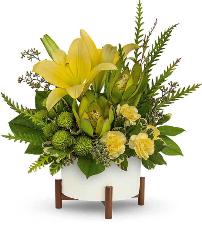 Modern Garden Bouquet flower arrangement by Days Flowers Florida, highlighting a sunny yellow Asiatic lily, yellow mini carnations, and texturized green leucadendron inside a gray mid-century planter with a wooden stand.