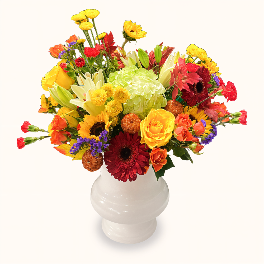 Rising Sun Garden autumn floral arrangement with yellow lilies, red roses, and mini Halloween pumpkins in a white vase by Days Flowers Florida.