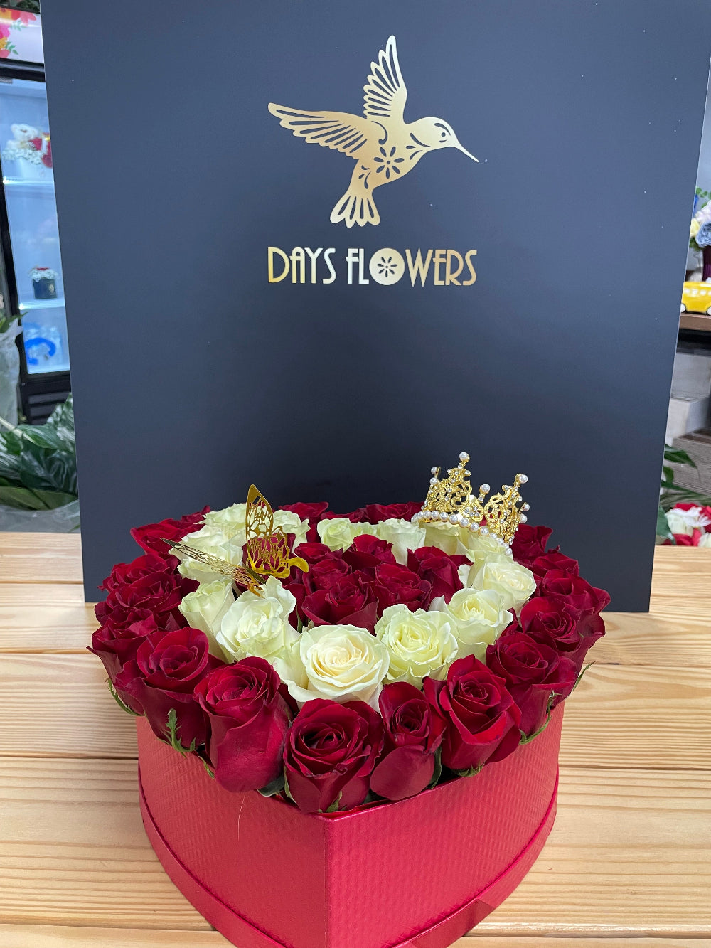 Elegant atmospheric presentation of the Royal Bloom Crown arrangement by Days Flowers Florida, perfect as a premium table centerpiece for luxury weddings and corporate galas.