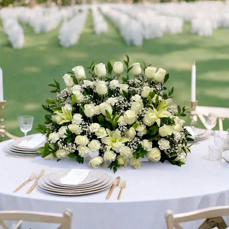 Top-down view of the White Harmony display showing the open white lilies nestled among vibrant green leaves.