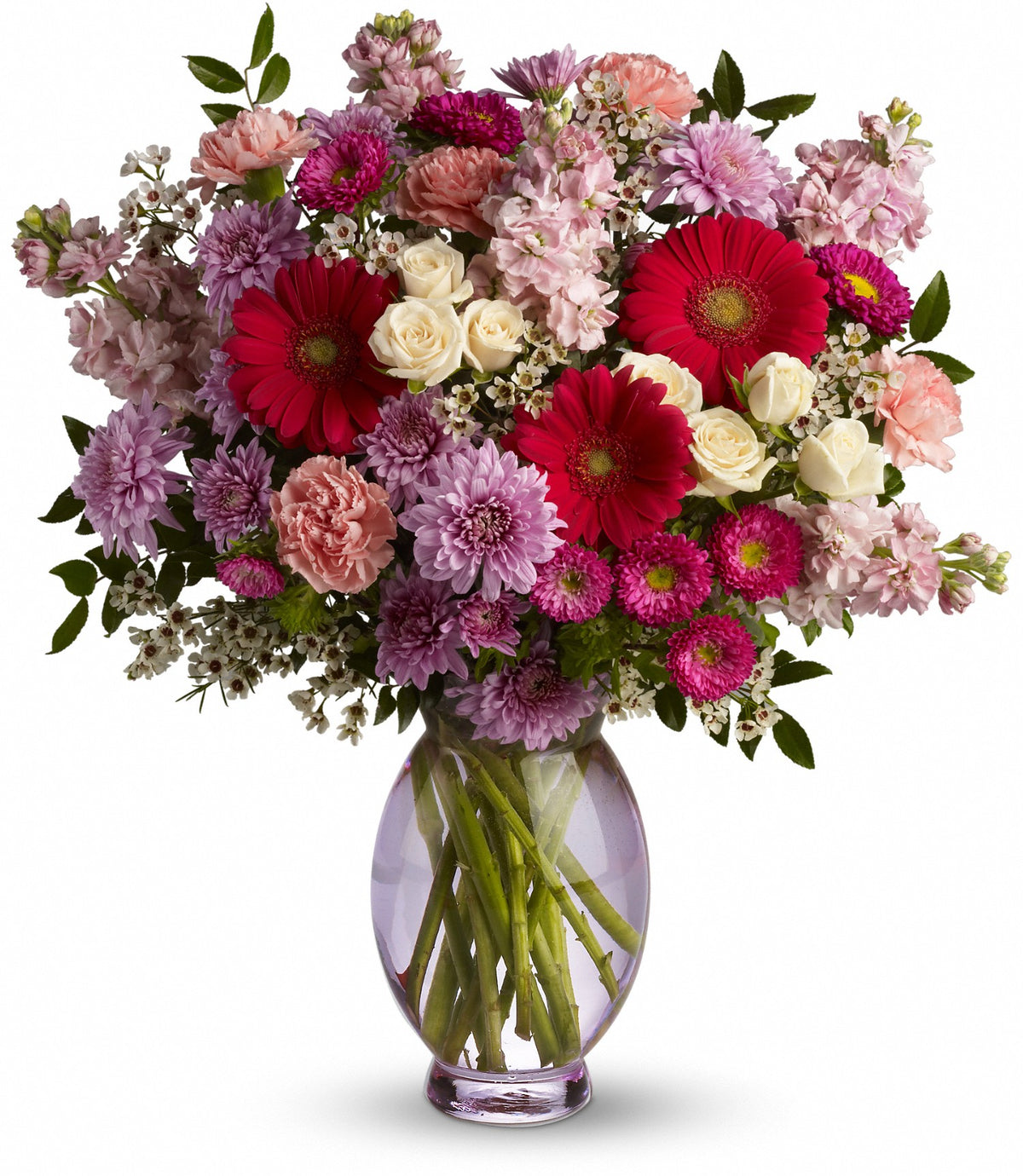 Perfectly Pleasing Pinks flower arrangement featuring hot pink gerberas, white spray roses, and pink stock in a tall lavender glass vase by Days Flowers Florida
