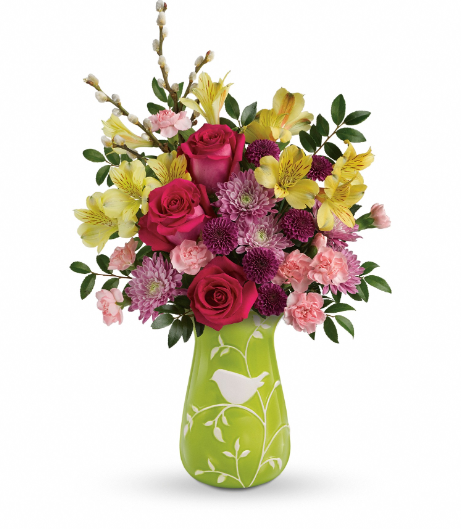Elegant floral arrangement with pink roses, yellow alstroemeria, and purple carnations in a green vase, perfect for delivery in Summerfield, Ocala, Orlando, The Villages, and Port St. Lucie.