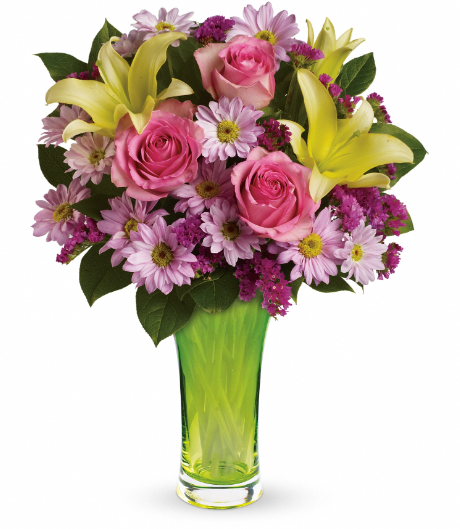 Elegant bouquet featuring pink roses, yellow lilies, and purple floral accents in a stylish green vase, perfect for delivery in Summerfield, Ocala, Orlando, The Villages, and Port St. Lucie.