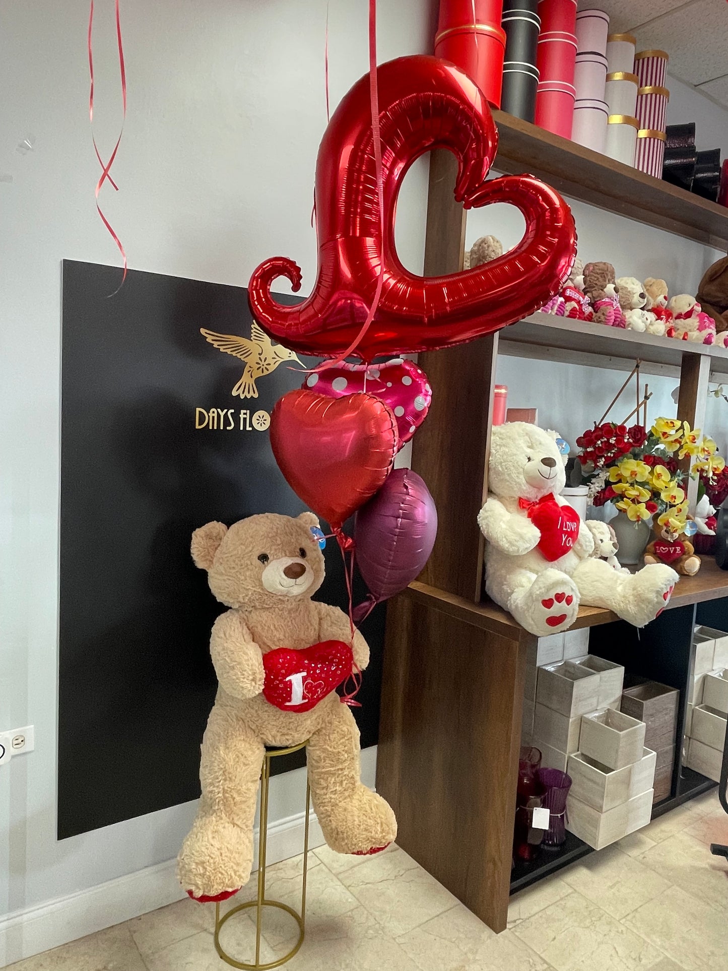 Days Flowers Florida: Bear Hug arrangement delivers smiles and hugs. Cuddly teddy bear and balloon assortment gift delivery in Port St. Lucie.