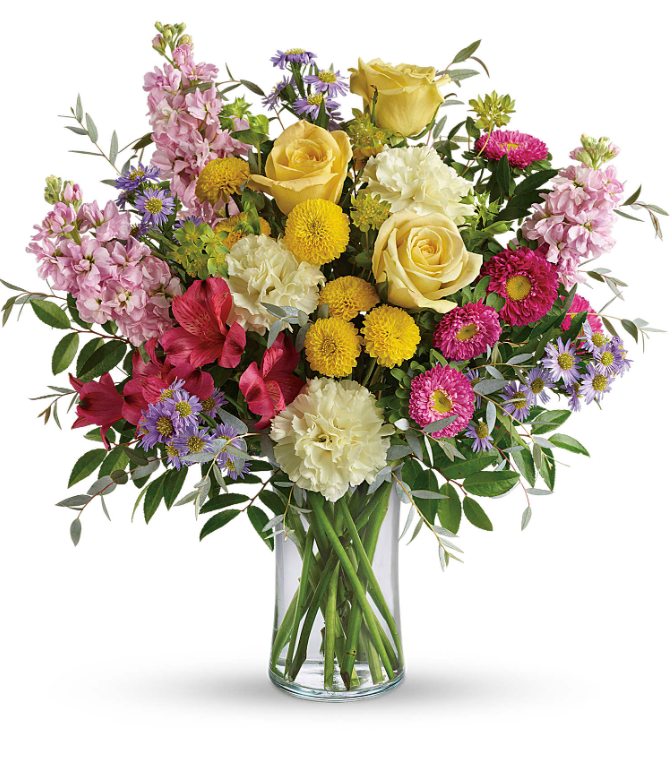 Vibrant bouquet of yellow roses, pink carnations, and purple asters in a glass vase, perfect for free delivery in Florida areas.