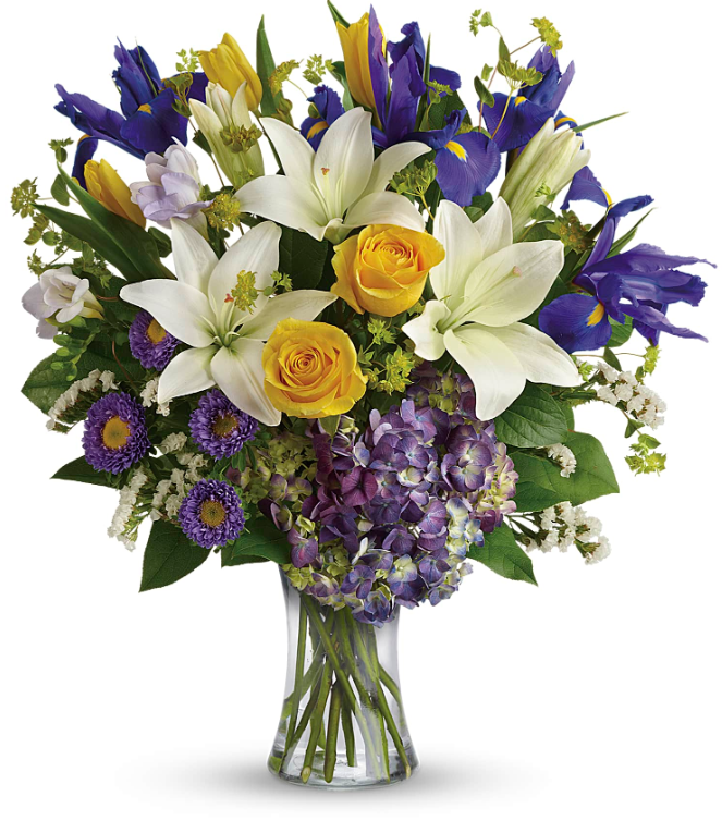 Vibrant bouquet of yellow roses, white lilies, and purple irises in a glass vase, perfect for free delivery in Florida areas.