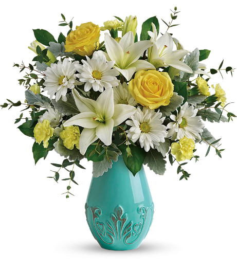 Aqua Dream Bouquet by Days Flowers Florida featuring yellow roses, white lilies, yellow miniature carnations, white daisies, dusty miller, eucalyptus, and lemon leaf in an aqua-glazed ceramic vase, designed as a bright spring floral arrangement.