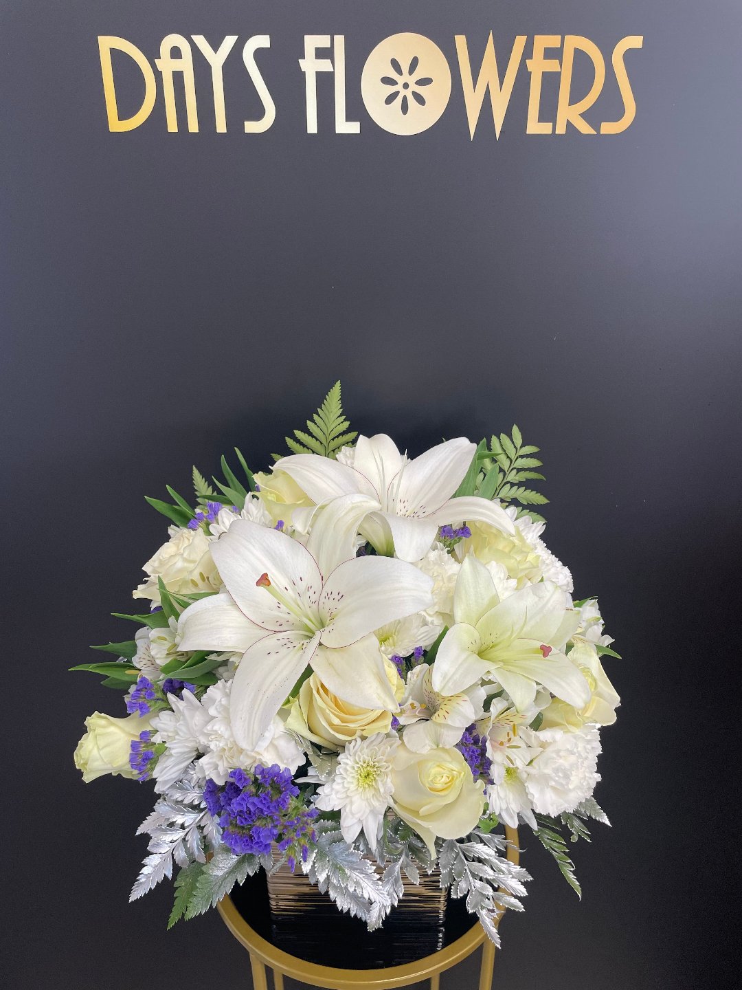 Elegant white and yellow floral arrangement from Days Flowers