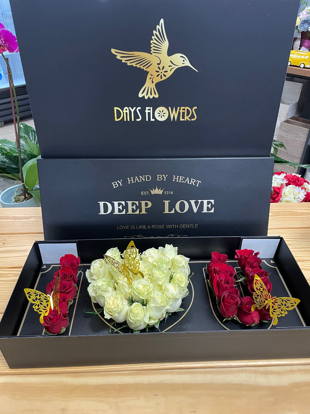 Luxury romantic display featuring the Deep Love Arrangement rose box by Days Flowers Florida, tailored as a stunning surprise centerpiece gift for marriage proposals and date nights.