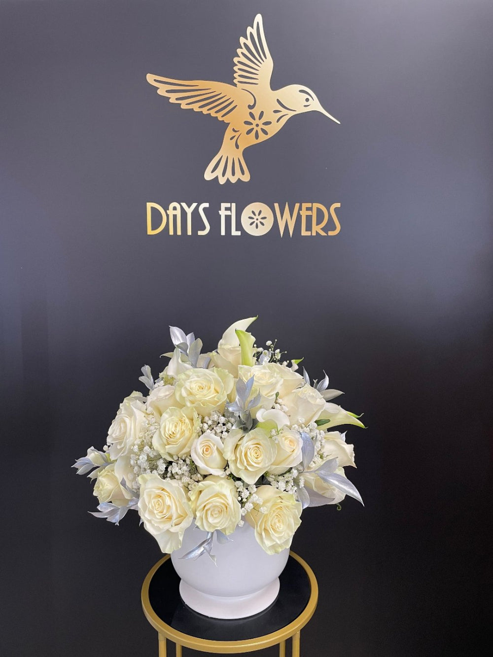 Elegant White Rose Bouquet with fresh white roses, baby’s breath, green foliage, and a refined ribbon finish, ideal for anniversaries, romantic gifts, appreciation flowers, and elegant celebrations in Summerfield, Florida.
