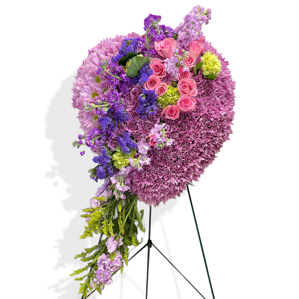 Full retail presentation of the heart-shaped sympathy flower wreath displayed prominently as a church altar centerpiece.