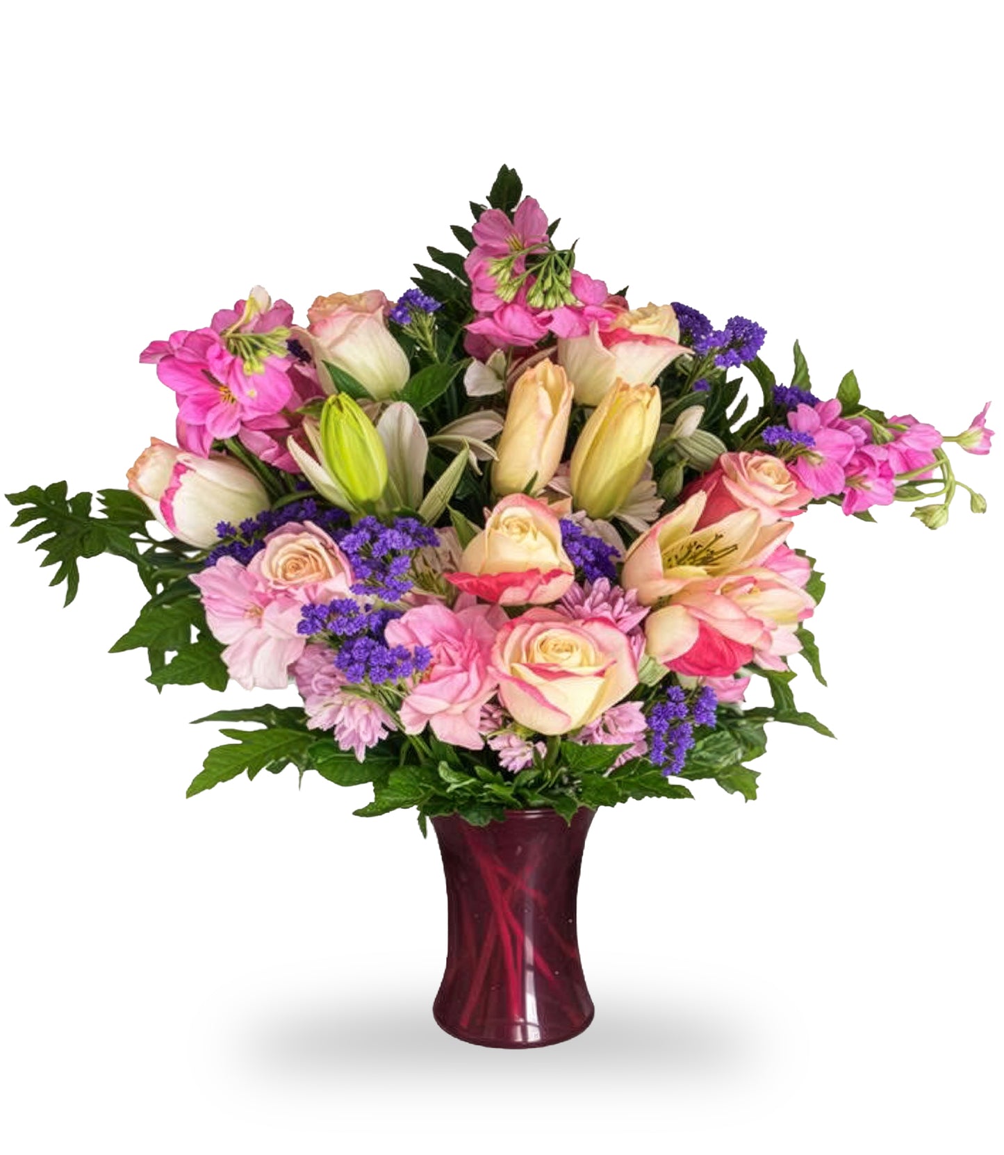 Enchanting Dream Garden arrangement by Days Flowers Florida, featuring pink roses, Asiatic lilies, and purple statice in a dark magenta glass vase