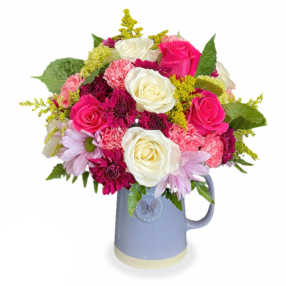 Eternal Spring Bouquet by Days Flowers Florida featuring elegant pink roses, white lilies, and vibrant red blossoms arranged in a chic grey watering can-style vase for a fresh spring floral look.