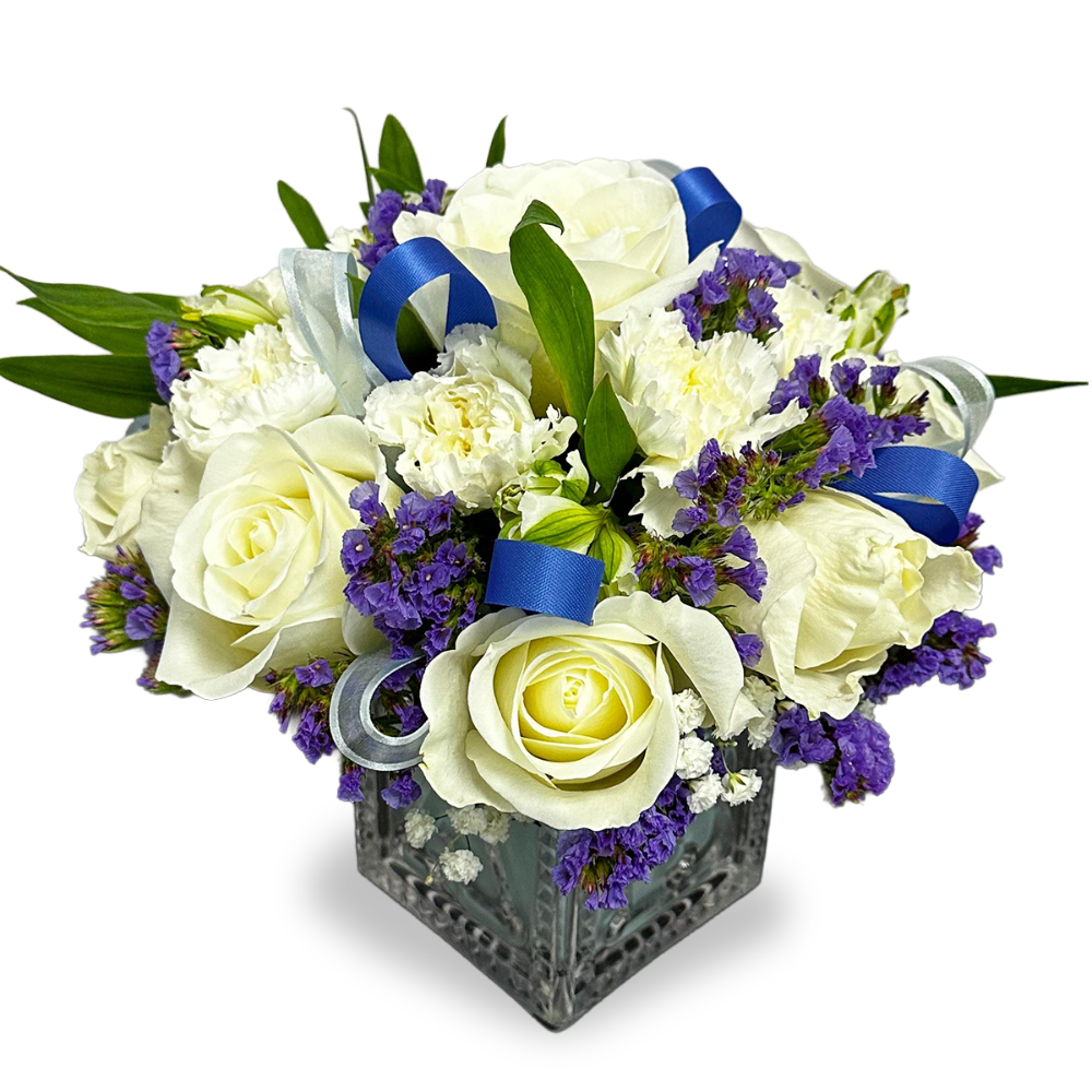 Close-up of the embossed glass baby block vase showing white carnations and decorative blue ribbon loops