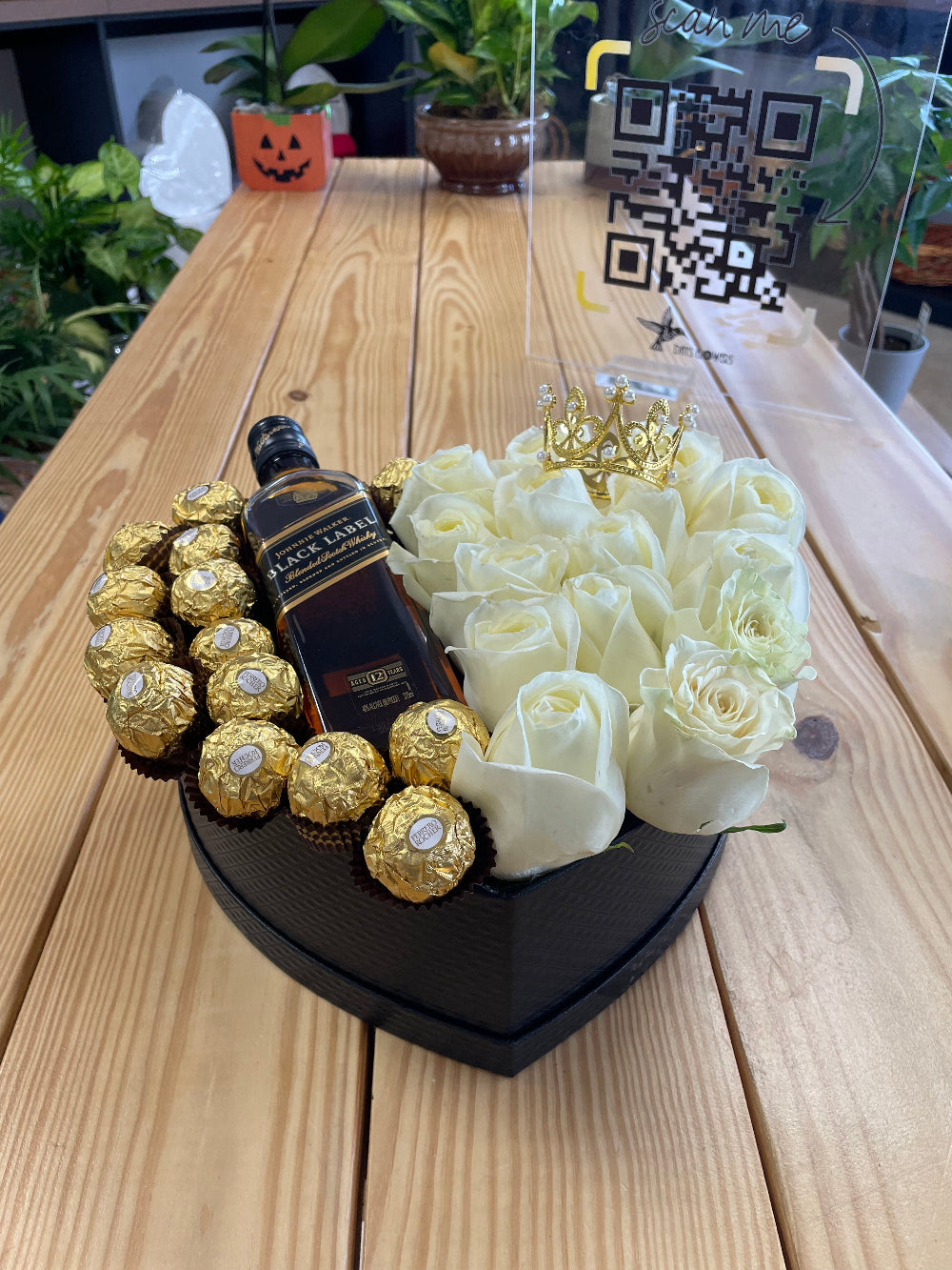 Hearts and Chocolates Arrangement with a medium box of roses, chocolates, and bottle presentation, designed by Days Flowers Florida for romantic gifts, special occasions, anniversaries, and elegant love celebrations.