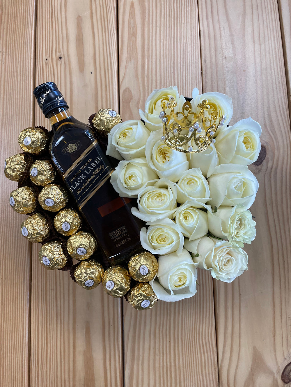 Hearts and Chocolates floral arrangement by Days Flowers Florida with roses, chocolates, and bottle presentation, created as a stylish Valentine’s Day gift or romantic floral surprise for someone special.