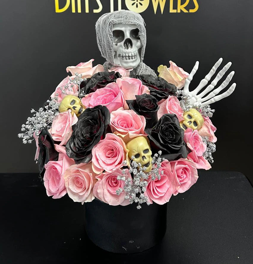 Days Flowers Florida: Elegant and spooky Halloween floral arrangement. Pink/black roses with golden skull accents. Dazzle your Ocala guests.