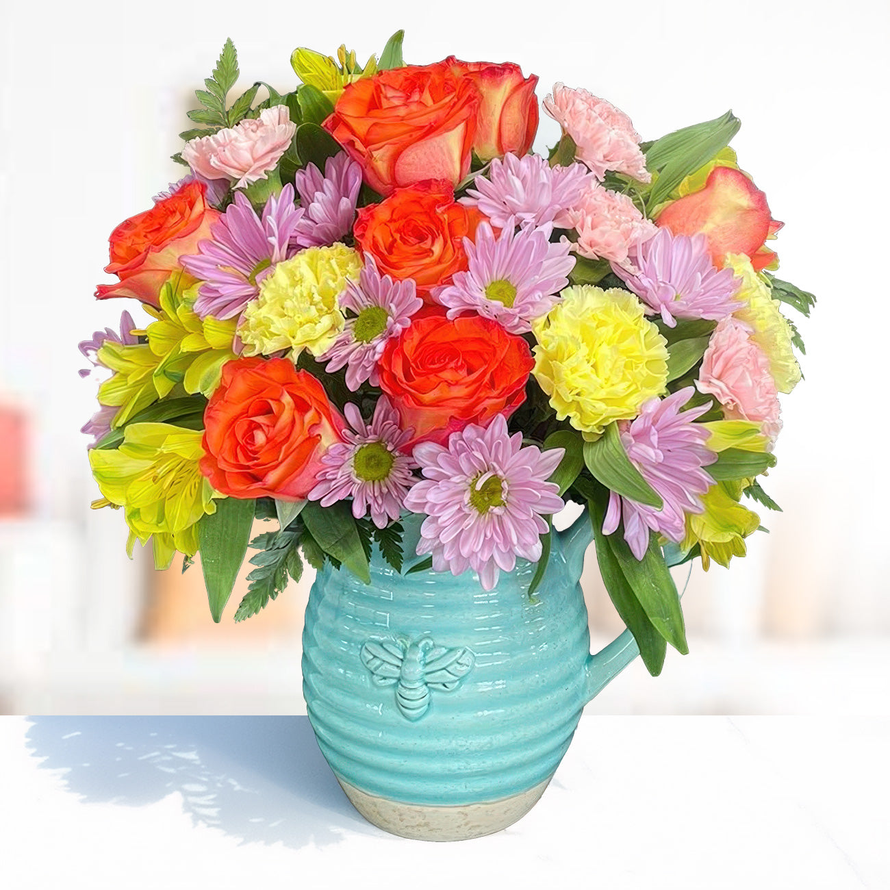 Days Flowers Florida: Sunny spring bouquet in iridescent ceramic pitcher. Orange roses, yellow alstroemeria, and pink carnations. Gift delivery in Summerfield, FL.