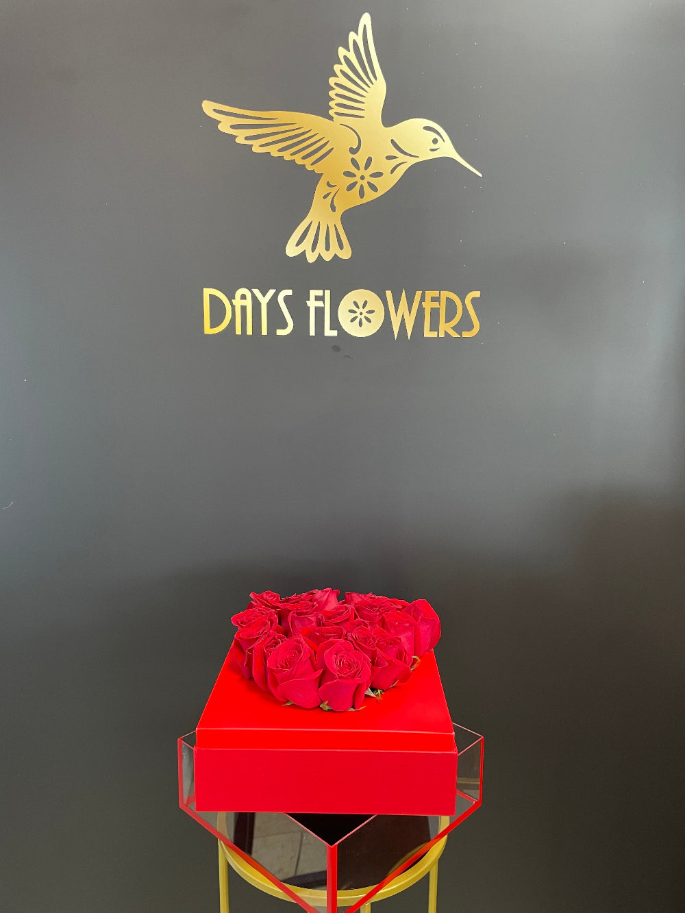 Artistic capture of the Radiant Romance Collection designer rose box, emphasizing the luxury monochromatic style that blends deep crimson roses with a matching designer box.