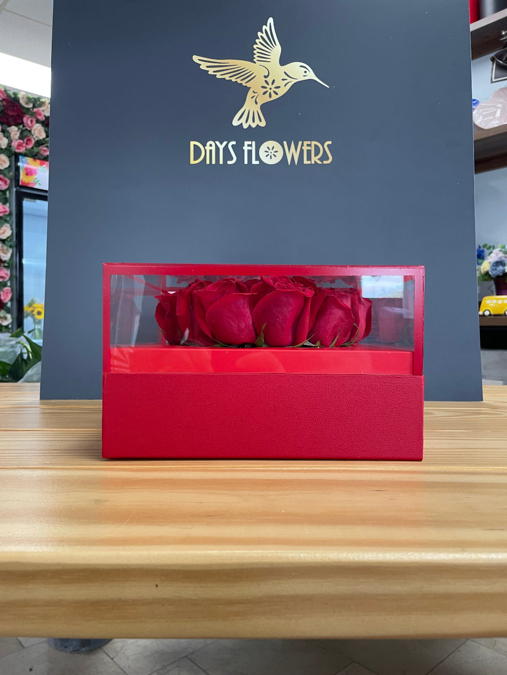 Premium Valentines Day presentation of the Radiant Romance Collection from Days Flowers Florida, showcasing the elegant cylindrical packaging filled to the brim with fine quality red blossoms.