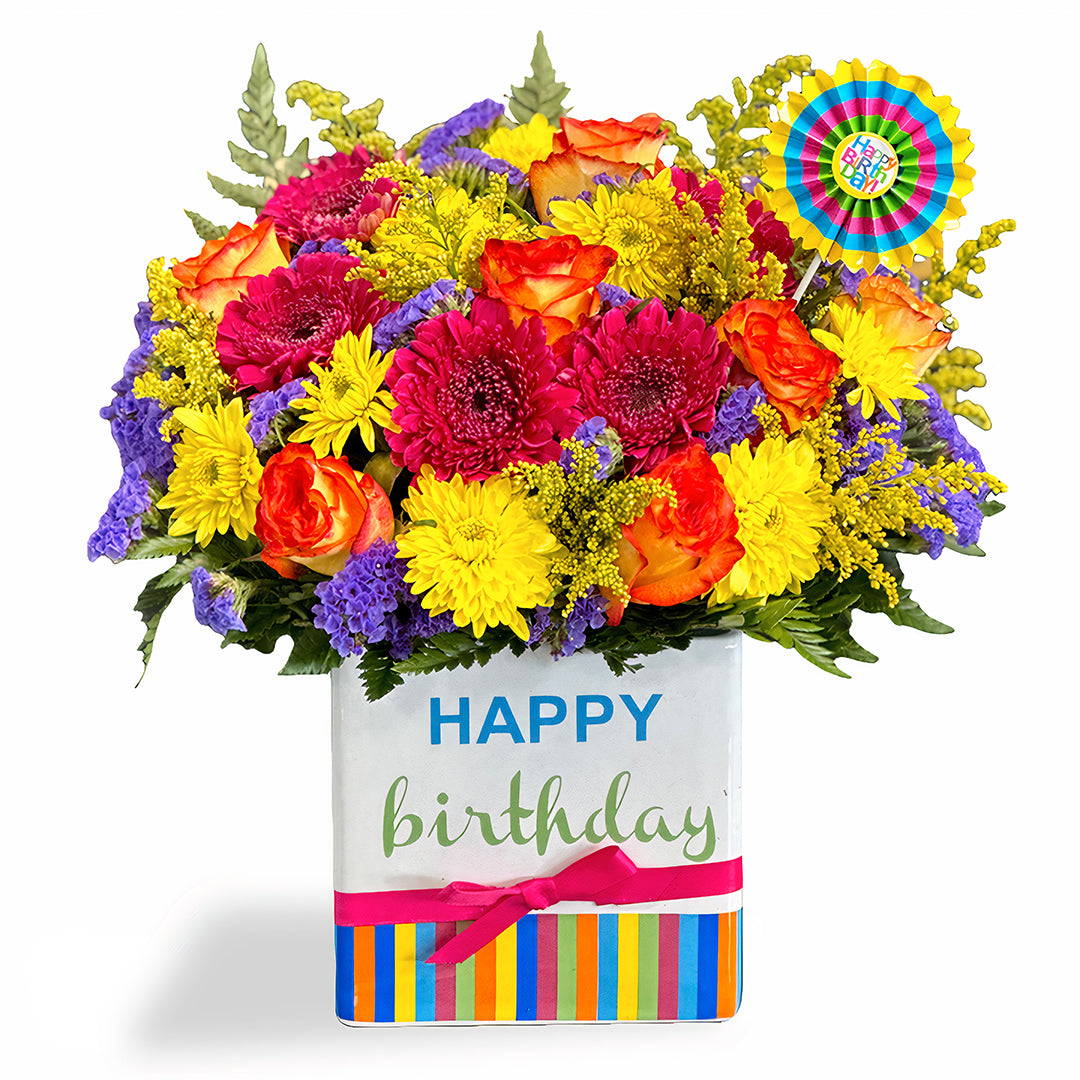 Days Flowers Florida: Radiant Joy Bouquet with sunflowers, red gerberas, and purple daisies. Cheerful gift in 'HAPPY' rainbow pot for Summerfield, FL.