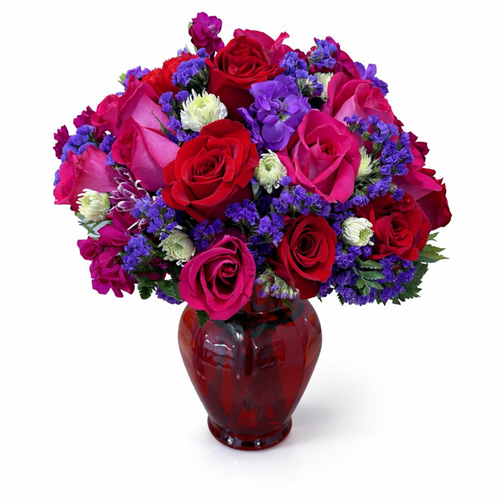Close-up of modern romantic bouquet showing the vibrant contrast of hot pink roses, purple statice, and white cushion mums.