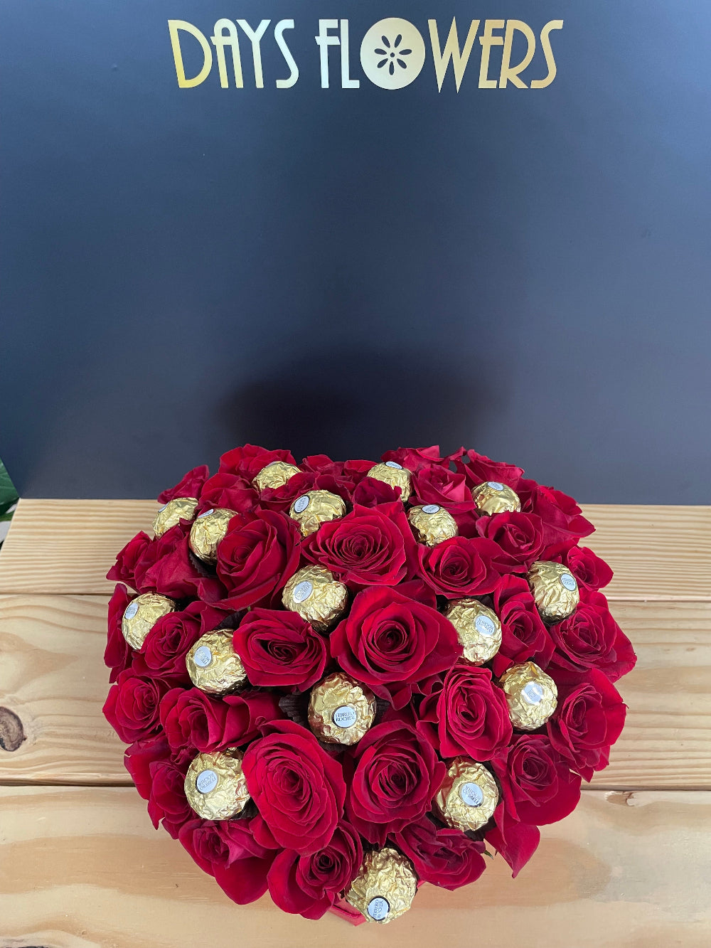 Premium holiday presentation of the Romance in a Box creation from Days Flowers Florida, showcasing the elegant gift box packaging filled to the brim with fine quality fresh blossoms.