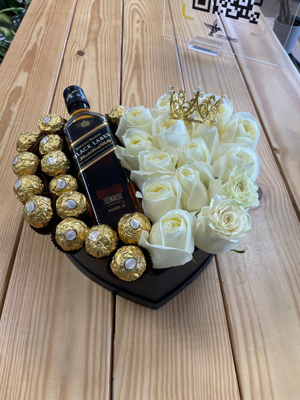 Romantic rose box arrangement with fresh roses, delicious chocolates, and a medium-size bottle presentation, perfect for Valentine’s Day, anniversaries, birthdays, and elegant romantic surprises in Summerfield, Florida.