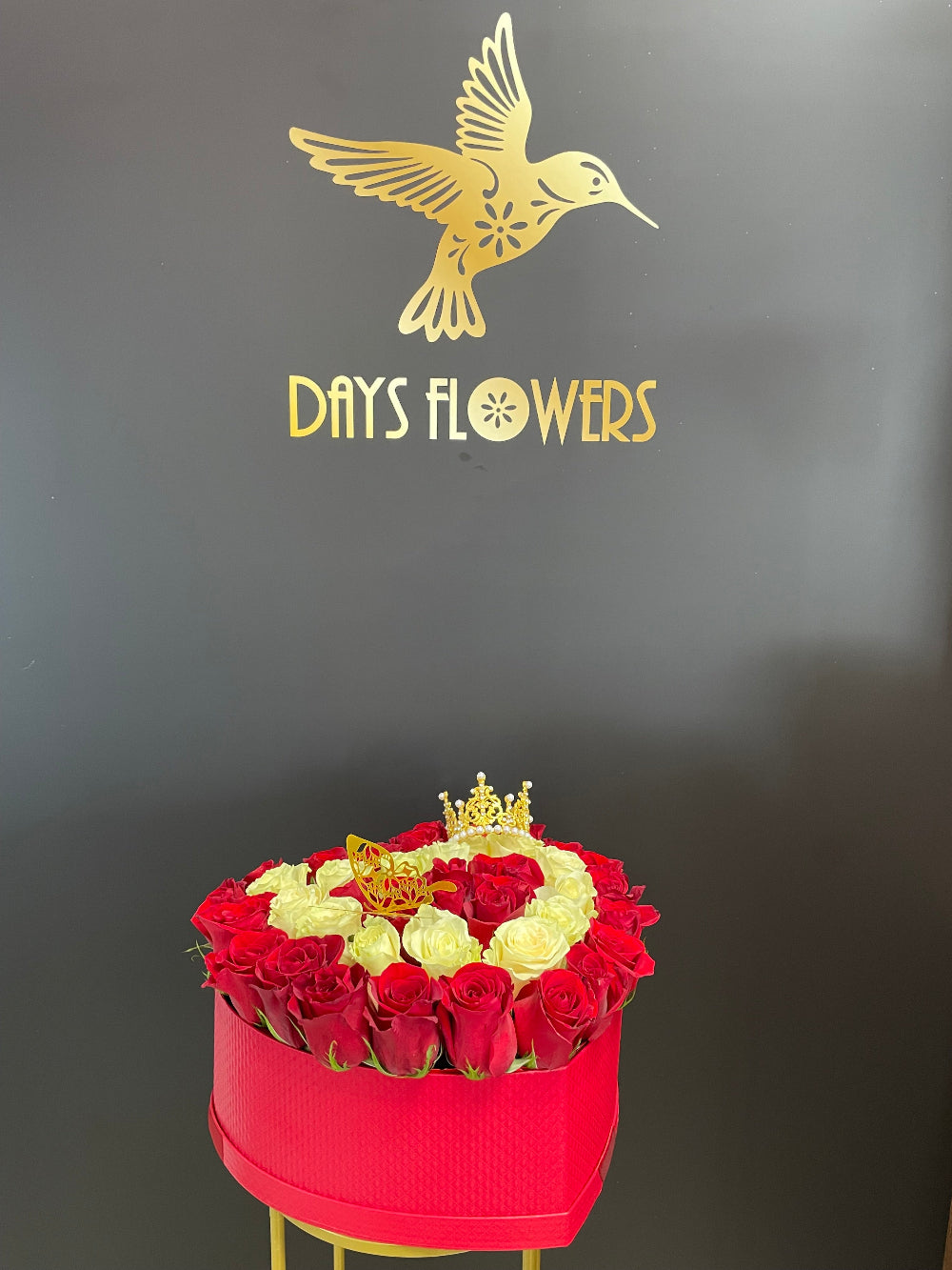 Close-up studio view of the Royal Bloom Crown design by Days Flowers Florida, capturing the vibrant red and clean white velvet textures of the roses crafted for elite celebrations.