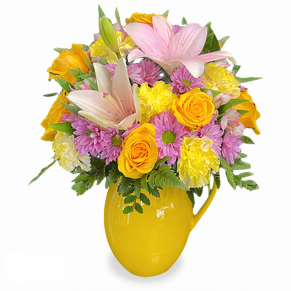 Sunny Tropics Bouquet featuring yellow roses, delicate pink lilies, and green foliage in a yellow vase by Days Flowers Florida.