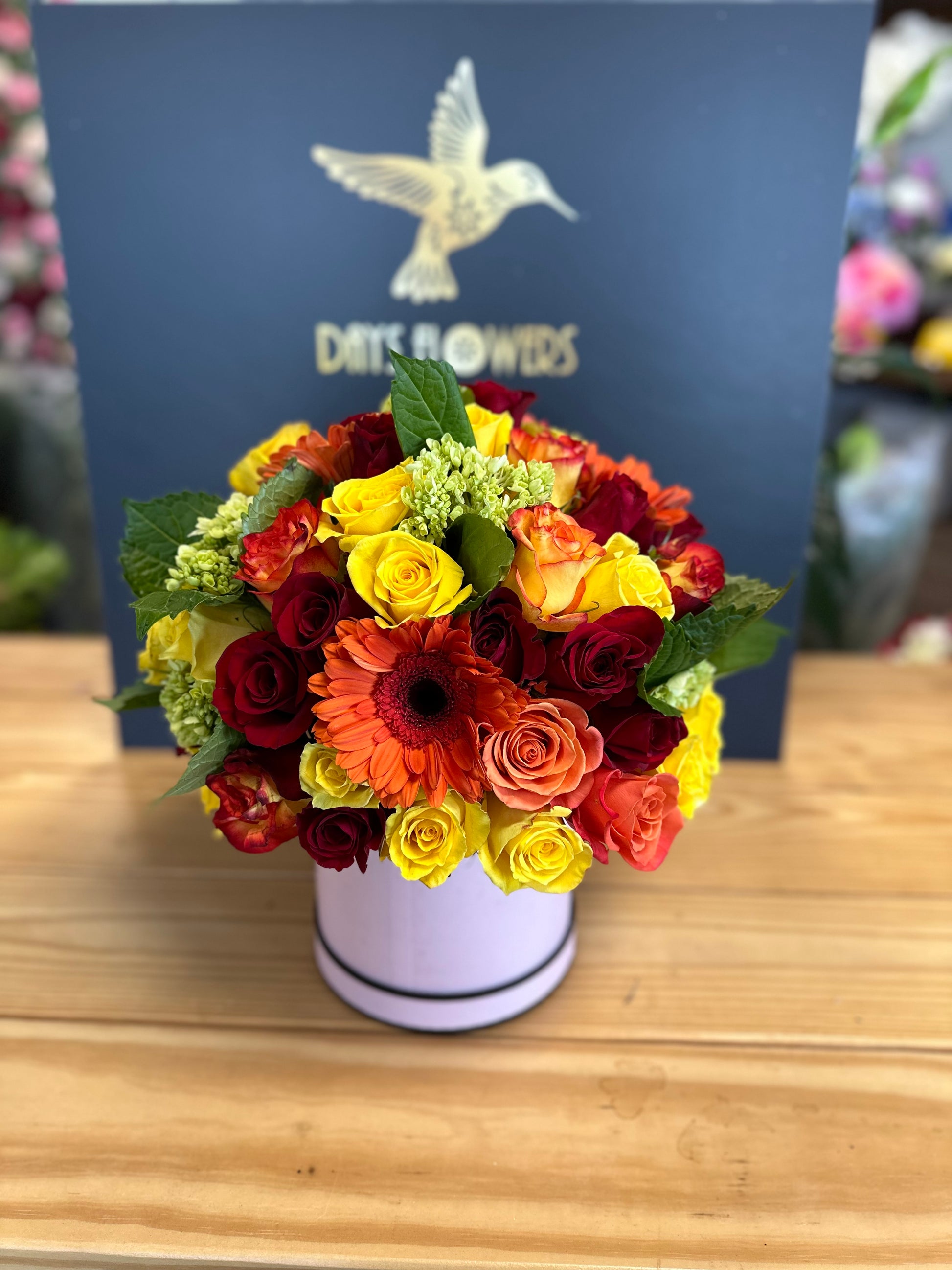 Days Flowers Florida: Vibrant red, orange, and yellow blooms for any occasion. Sunrise Splendor Bouquet gift delivery in Port St. Lucie.