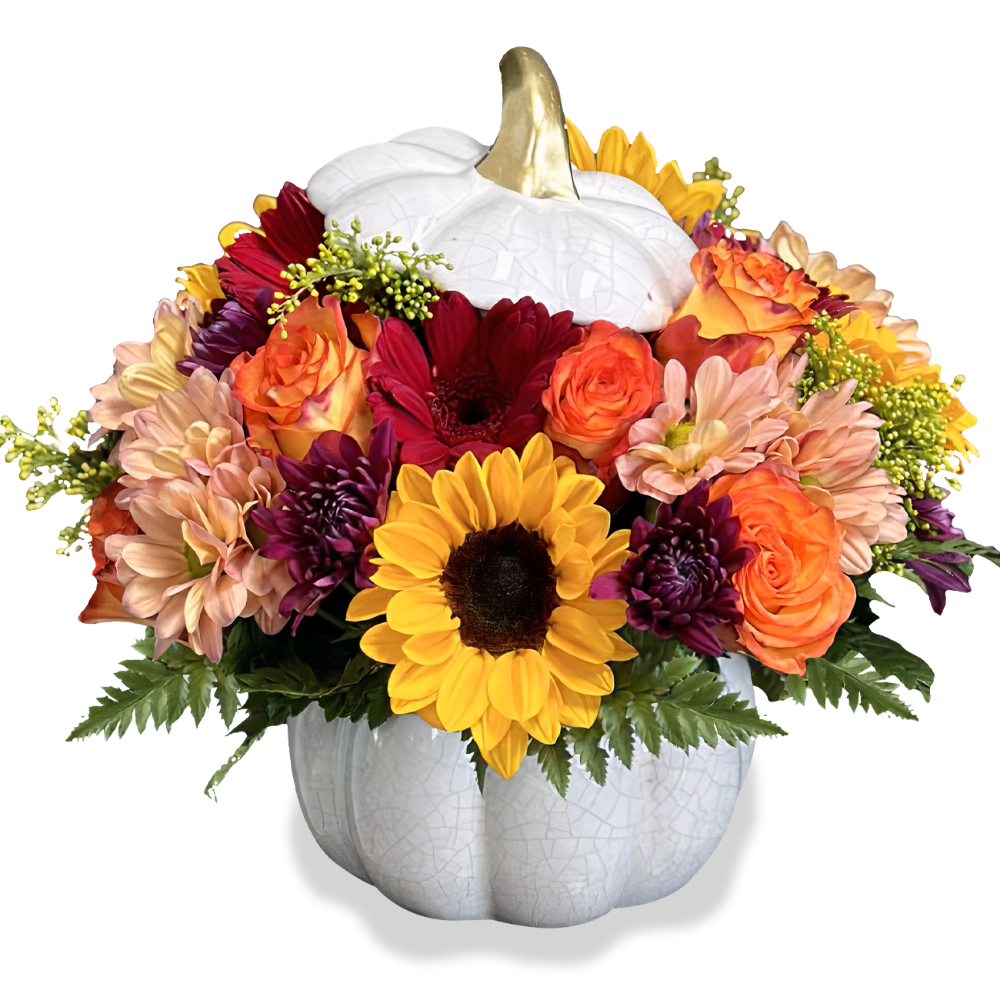 Autumn Splendor Floral Pumpkin arrangement featuring yellow sunflowers, orange roses, and red daisies in a white pumpkin vase with a gold stem by Days Flowers Florida