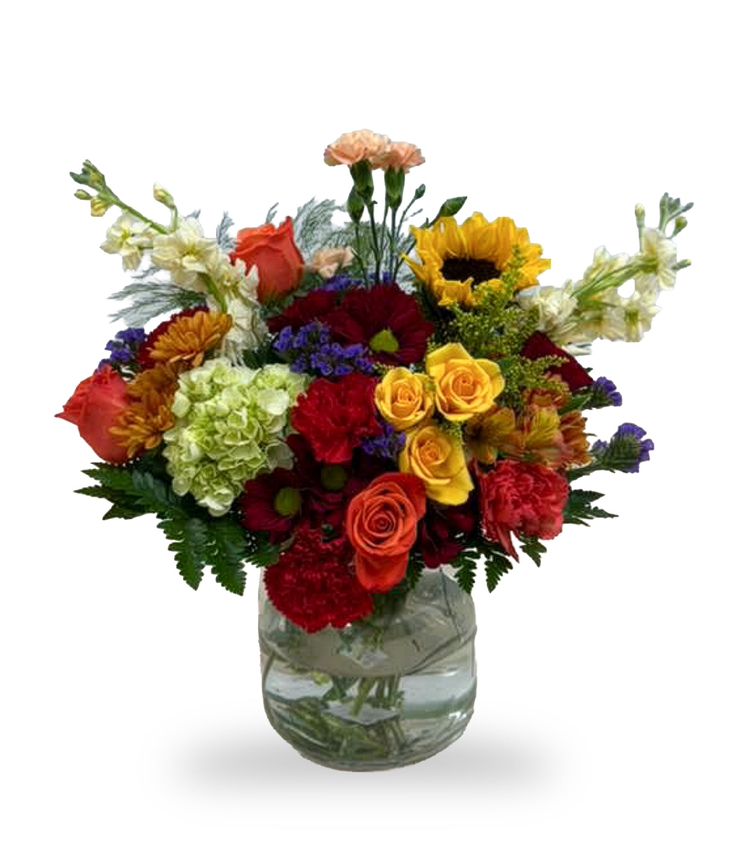Autumn Sunset & Sunflower Splash arrangement by Days Flowers Florida, featuring a yellow sunflower, orange roses, red carnations, and a green hydrangea in a clear glass bubble vase