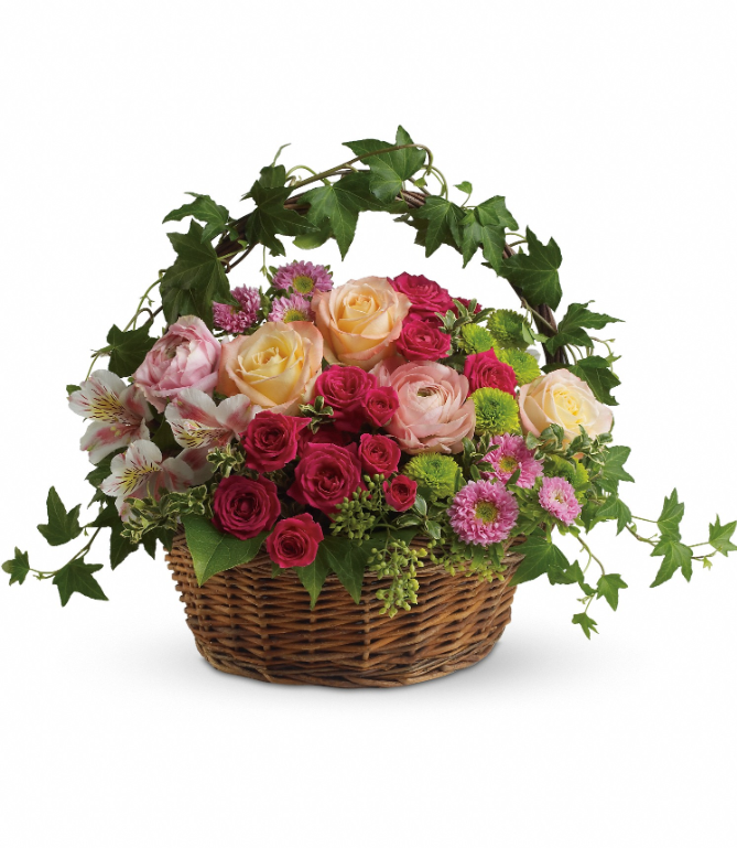 Elegant wicker basket with pink, red, and cream roses, daisies, and greenery, available for delivery in Summerfield, Ocala, Orlando, The Villages, and Port St. Lucie.