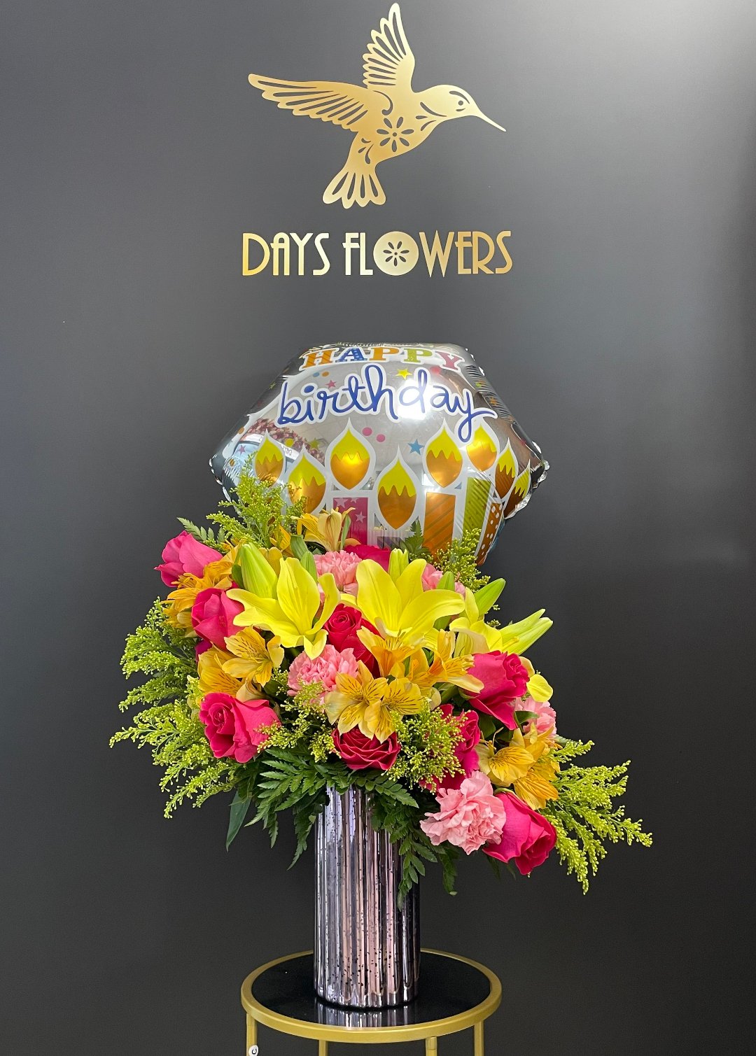 Vibrant birthday floral arrangement with balloon, free delivery in Summerfield, Ocala, Orlando, The Villages, and Port St. Lucie.