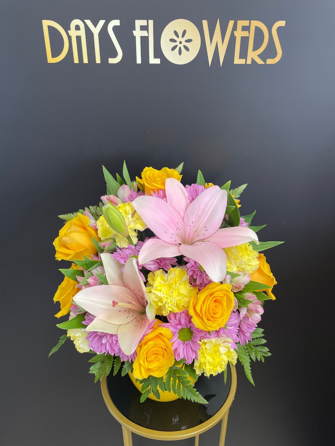 Top-down perspective of the Sunny Tropics Bouquet showing sunny yellow roses paired with pink lilies