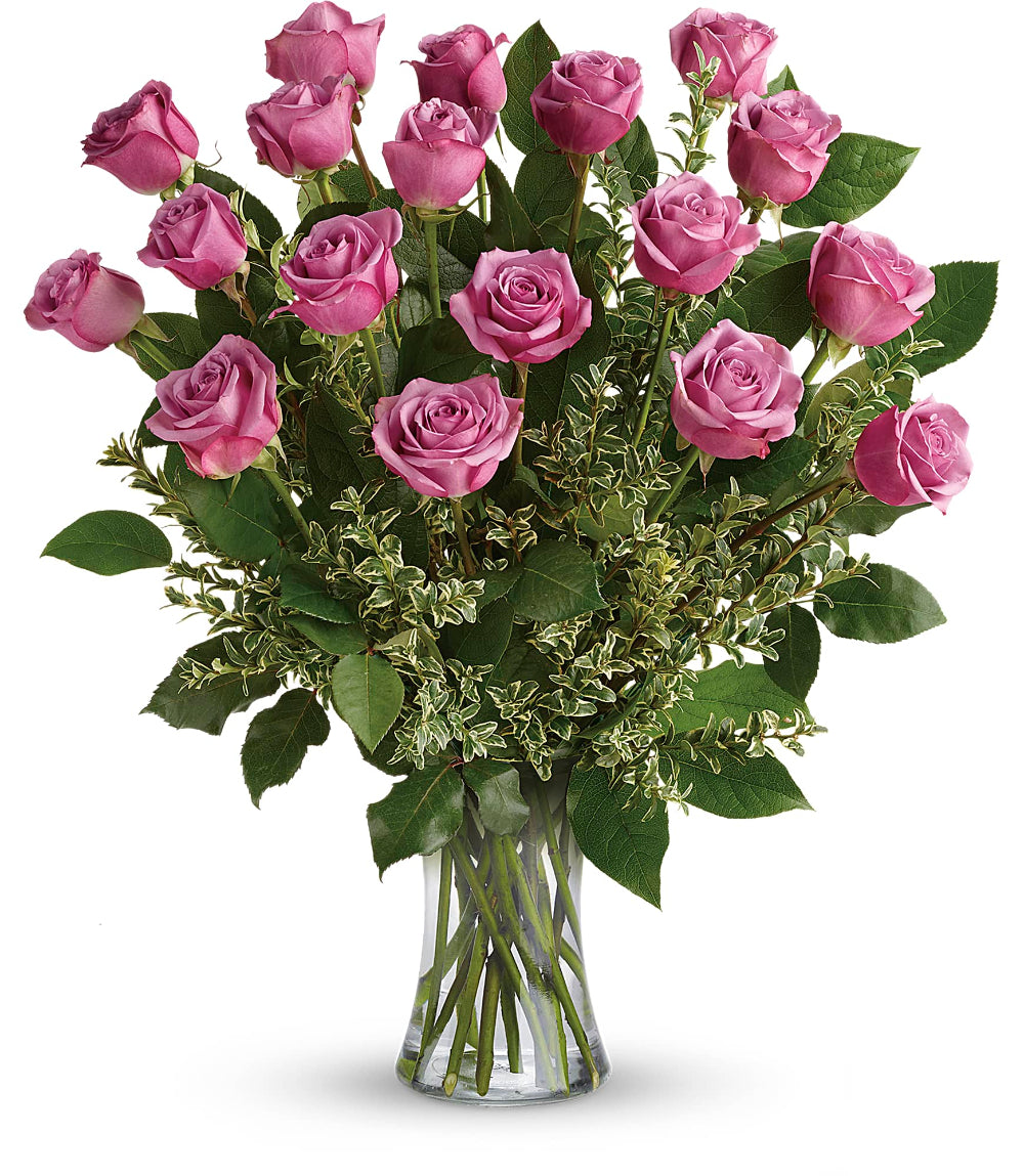 Close-up of the 8-inch clear glass gathering vase displaying green lemon leaf greenery and thick lavender rose stems.