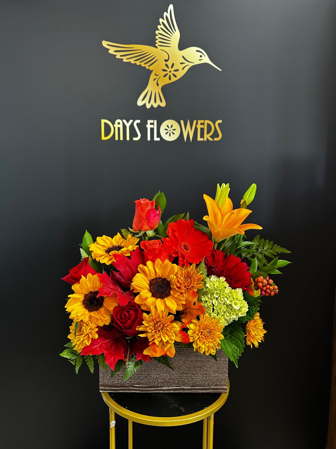Top-down perspective of the Rustic Radiance Bouquet showing opening yellow lilies and deep red dahlias