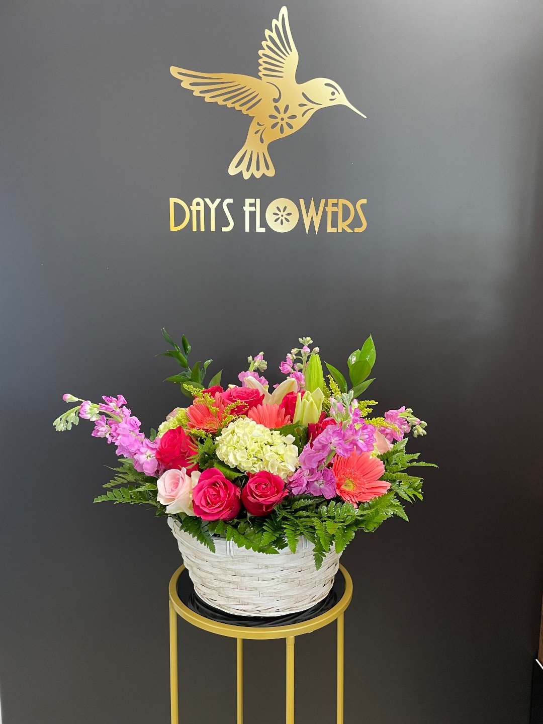 Elegant floral arrangement by Days Flowers with roses, lilies, and greenery in a white basket, perfect for delivery in Summerfield, Ocala, Orlando, The Villages, and Port St. Lucie.