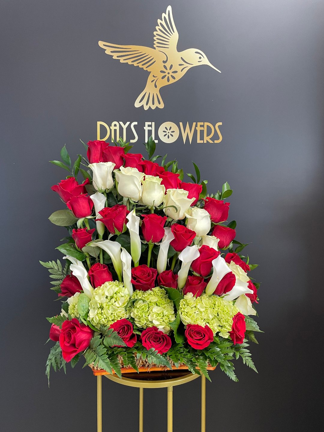 Elegant floral arrangement with red roses and white lilies, available for delivery in Florida