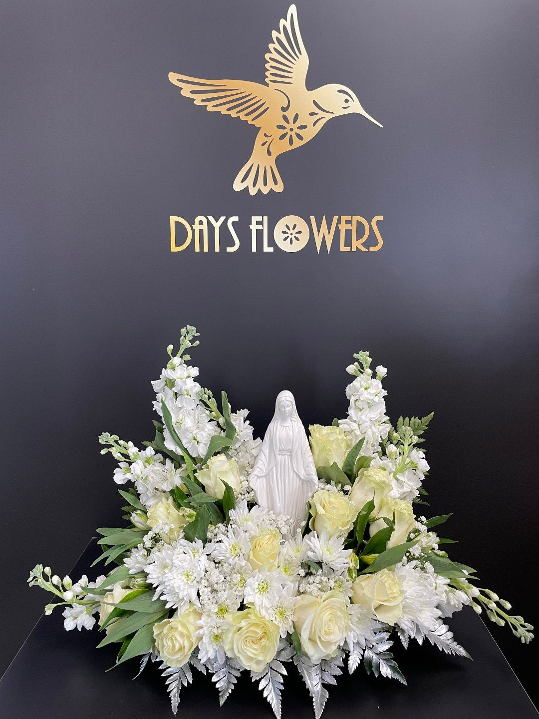 Elegant white floral arrangement with roses and lilies, perfect for delivery in Florida