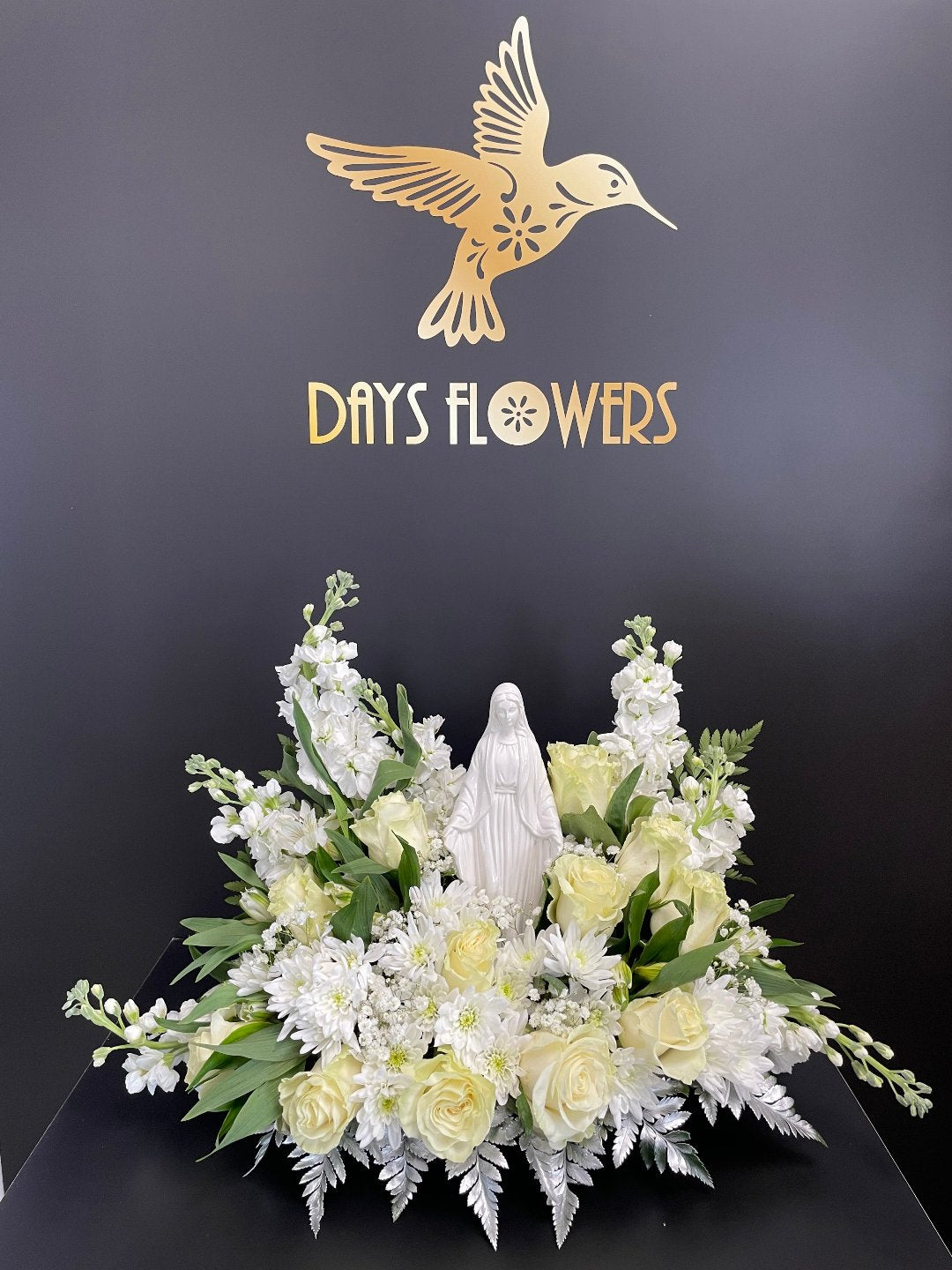 Elegant white floral arrangement with roses and lilies, perfect for delivery in Florida