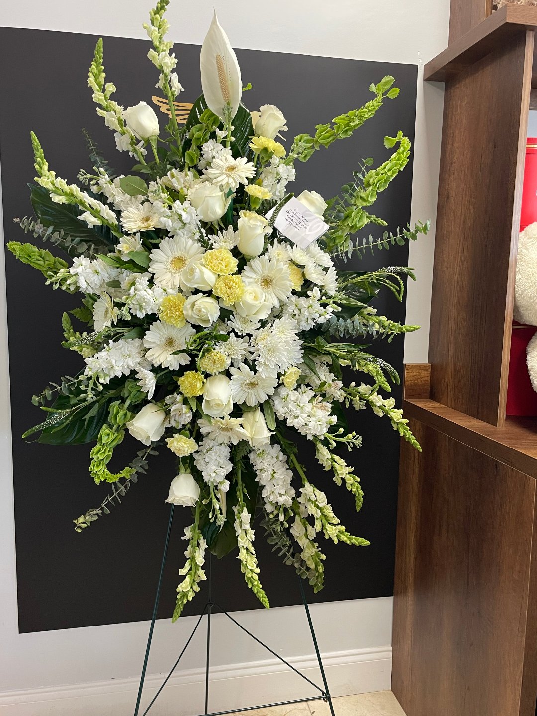 Elegant white floral arrangement with lilies, roses, and snapdragons, perfect for free delivery in Florida areas.