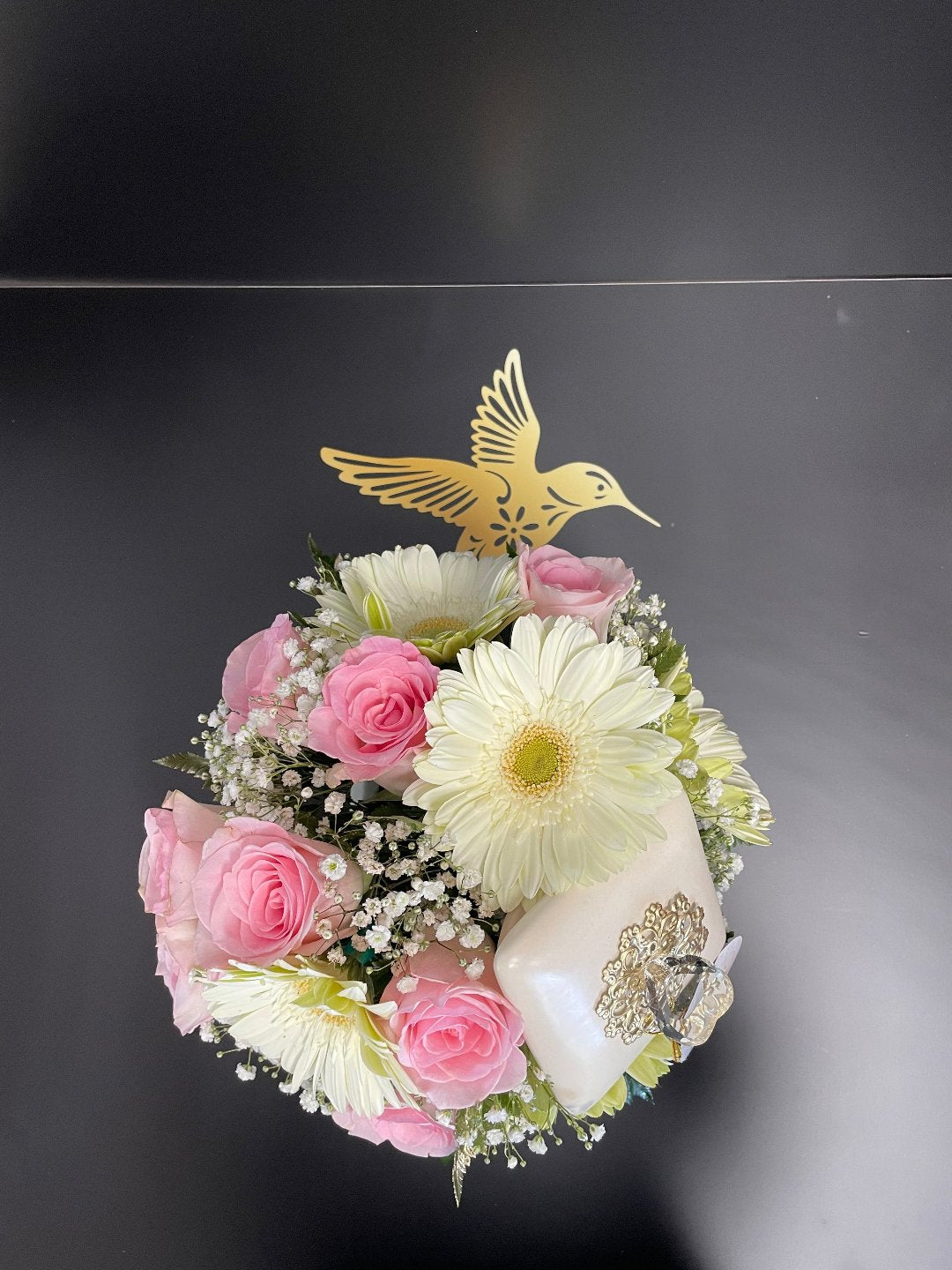 Pink roses, white daisies, and baby’s breath with golden bird accent by Days Flowers, delivery in Florida.