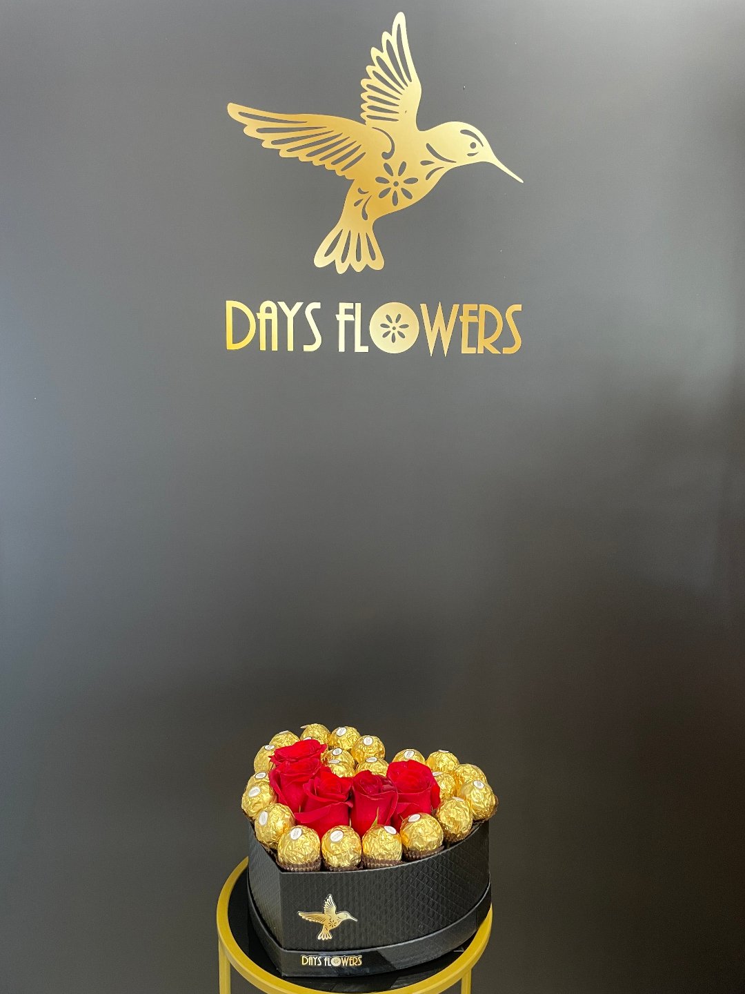 Heart-shaped floral arrangement with golden chocolates by Days Flowers, delivery in Florida.