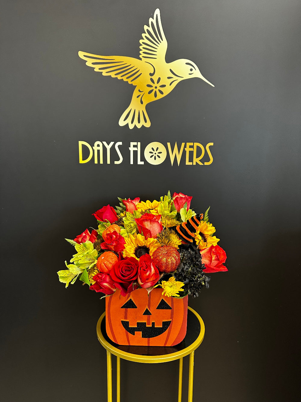 Close-up of fiery orange blossoms paired with dark, moody foliage accents.