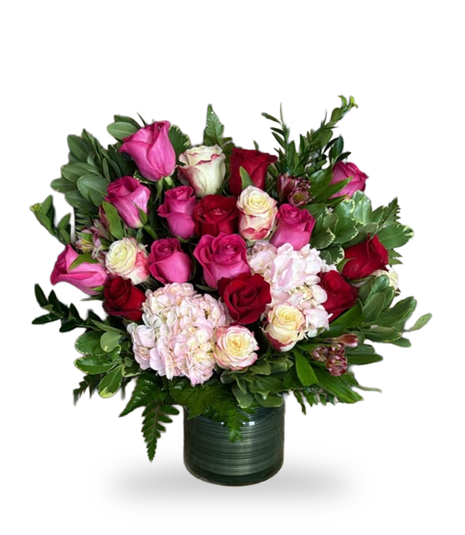 Harmonic Velvet & Rose Harmony Arrangement by Days Flowers Florida, featuring deep red roses, hot pink roses, cream-pink roses, and pink hydrangeas in a dark ribbed glass cylinder vase