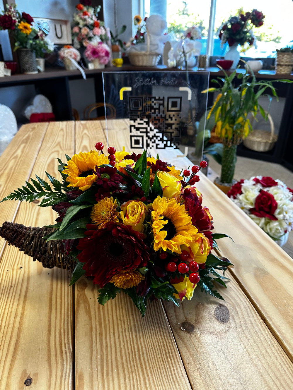 Top-down perspective of the Golden Autumn Centerpiece showing overflowing orange daisies and crimson roses.