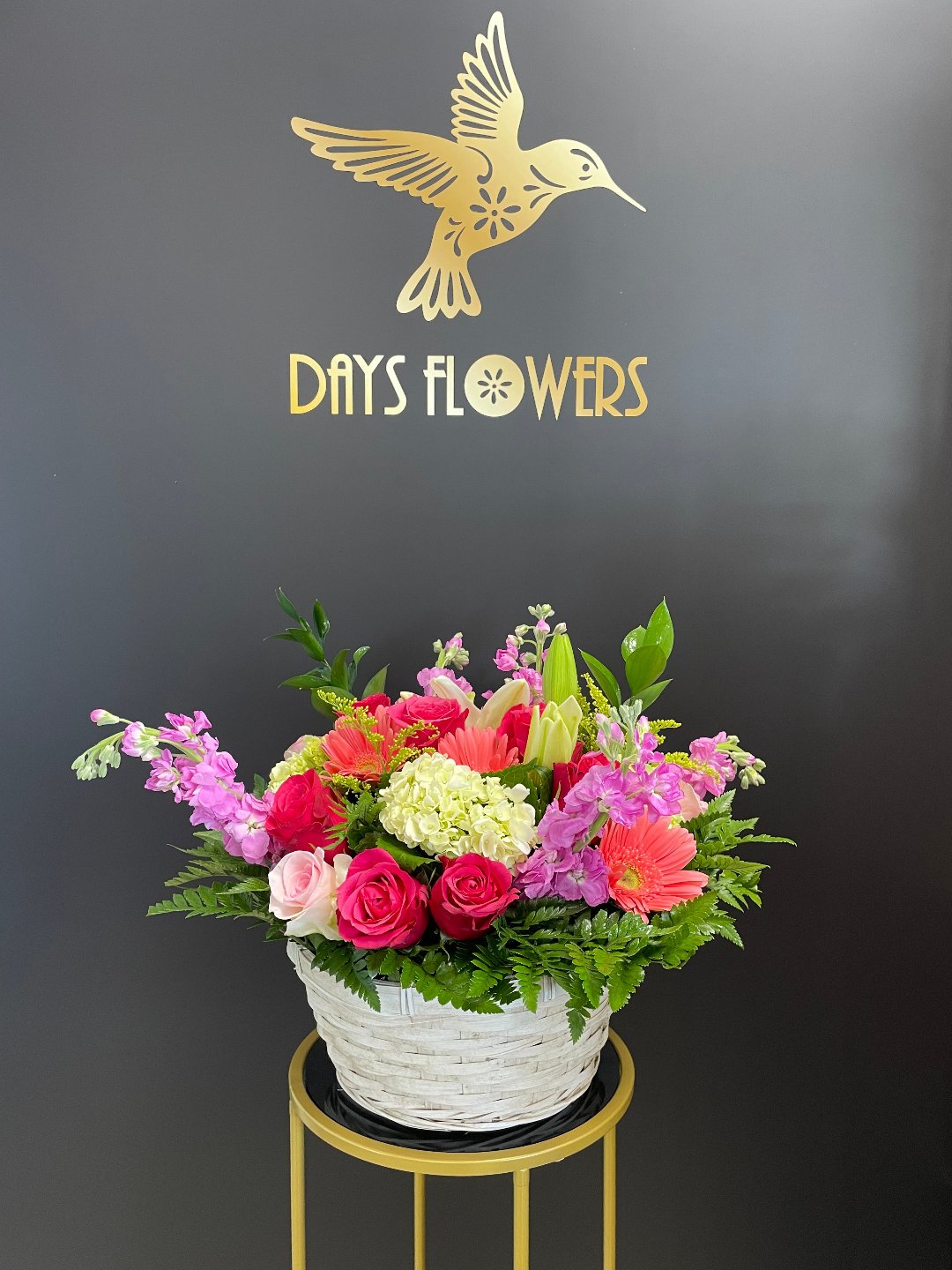 Top-down perspective of the Radiance in Bloom Basket showing pink roses paired with cloud-like white hydrangeas.